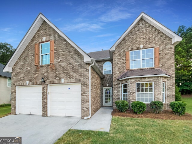 traditional home featuring a garage, concrete driveway, brick siding, and a front yard