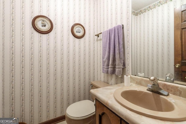 bathroom featuring toilet and vanity