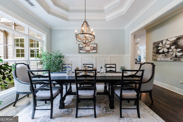 dining area featuring a chandelier, plenty of natural light, and ornamental molding