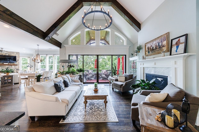 living room with dark hardwood / wood-style flooring, beamed ceiling, high vaulted ceiling, a high end fireplace, and a chandelier