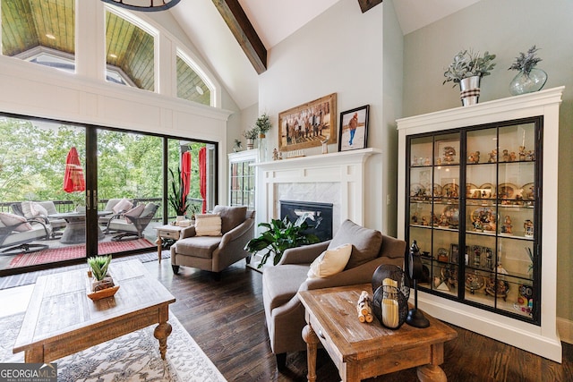 living room with high vaulted ceiling, dark hardwood / wood-style flooring, beamed ceiling, and a fireplace