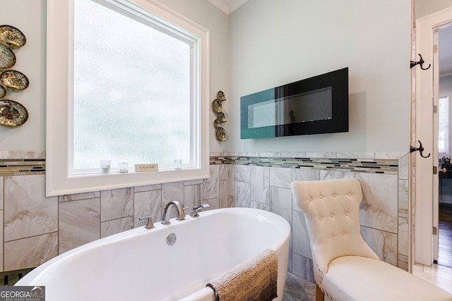 bathroom with tile walls and a tub