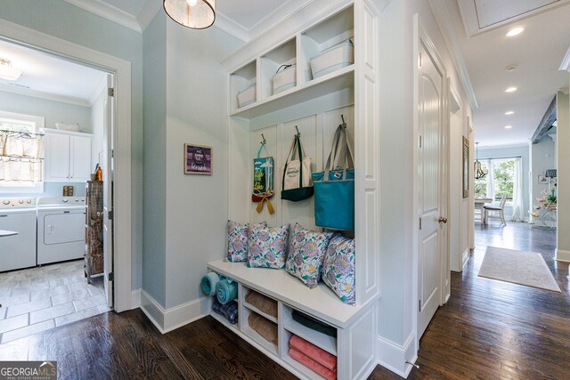 mudroom featuring dark hardwood / wood-style floors, crown molding, and washing machine and clothes dryer