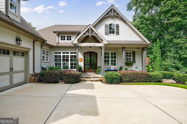 view of front of home with a garage and a porch