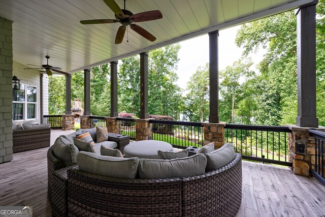 deck with ceiling fan and an outdoor living space