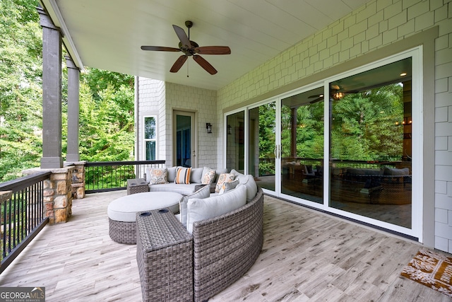 wooden deck featuring ceiling fan and outdoor lounge area