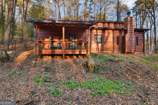 rear view of property featuring a deck