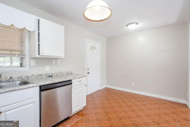 kitchen featuring baseboards, white cabinetry, light countertops, and stainless steel dishwasher