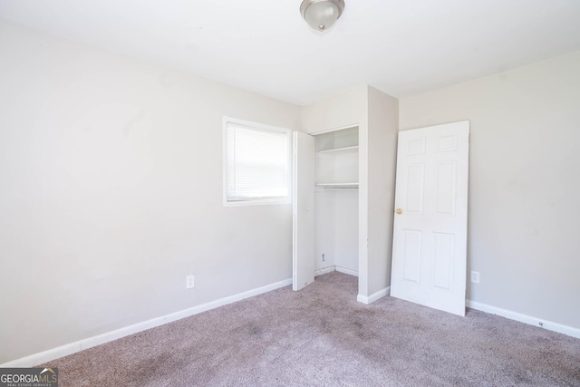 unfurnished bedroom featuring a closet, carpet flooring, and baseboards