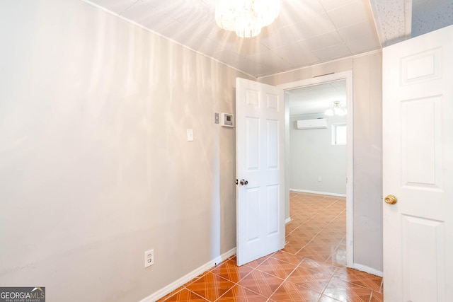 corridor with a notable chandelier, a wall mounted air conditioner, tile patterned flooring, and baseboards