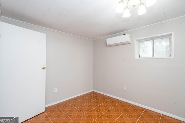 spare room featuring an AC wall unit and baseboards