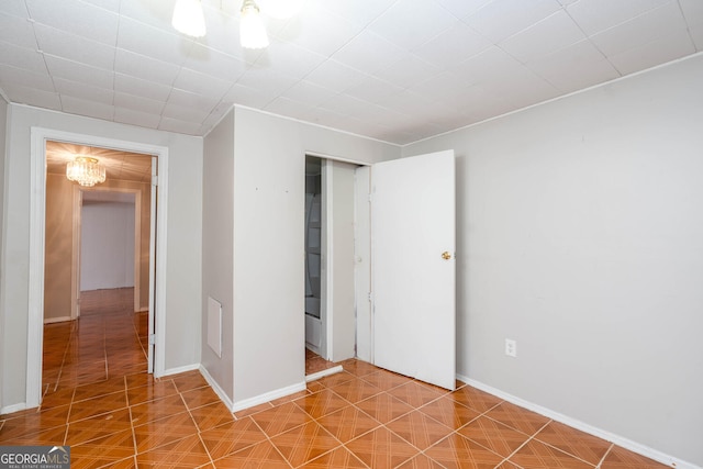 unfurnished bedroom featuring a closet, tile patterned floors, visible vents, and baseboards