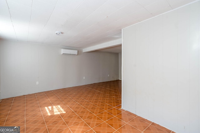 spare room featuring a wall unit AC and tile patterned floors