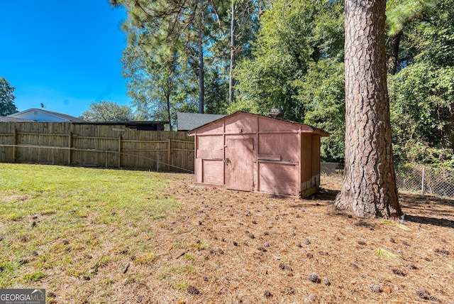 view of shed with a fenced backyard