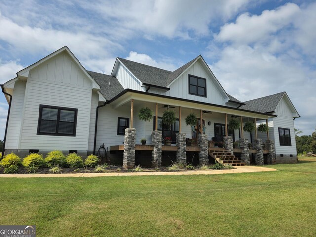 modern farmhouse style home featuring covered porch and a front lawn