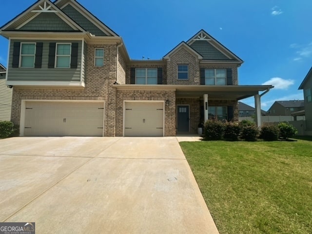 craftsman-style house with a garage and a front lawn