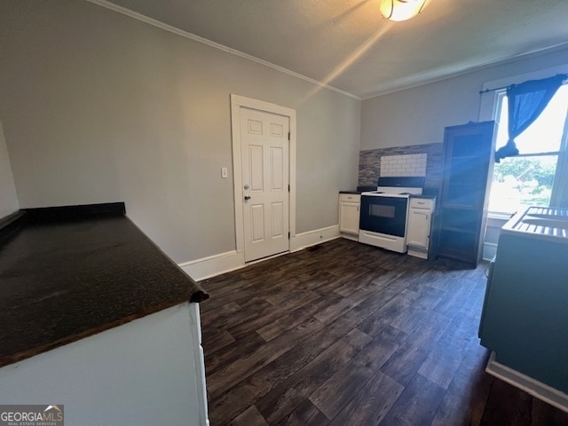 kitchen with white cabinets, crown molding, dark wood-type flooring, and white electric range