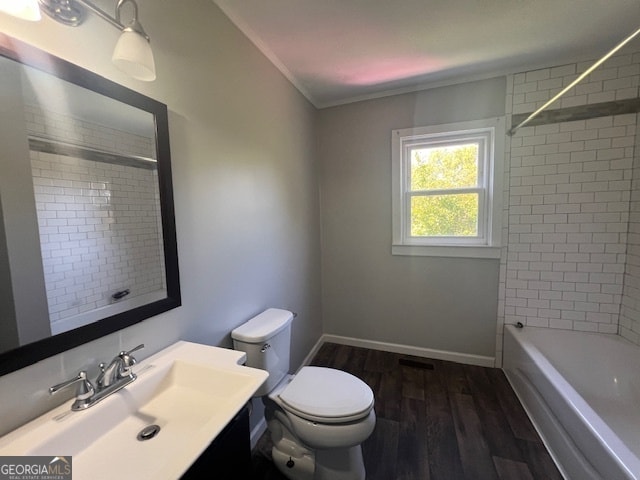 full bathroom featuring tiled shower / bath combo, wood-type flooring, toilet, and vanity