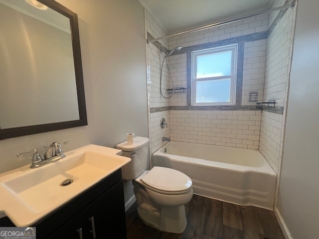 full bathroom with toilet, tiled shower / bath, wood-type flooring, and vanity