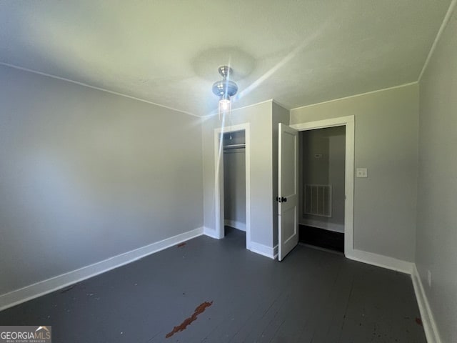 unfurnished bedroom featuring a closet and wood-type flooring