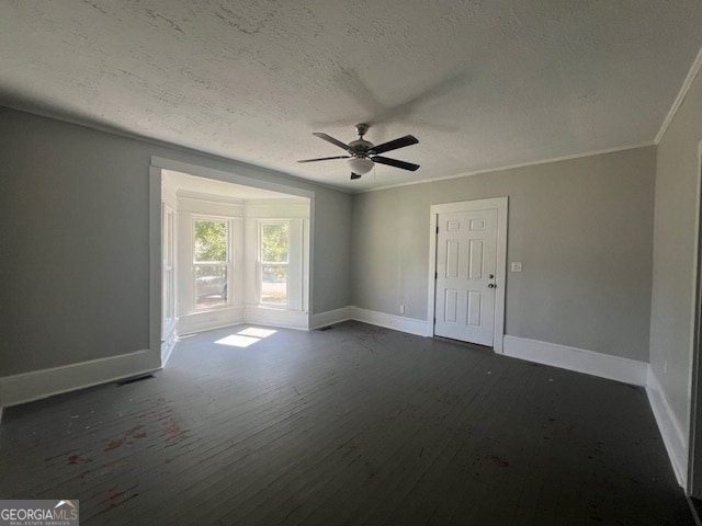 empty room with dark hardwood / wood-style flooring, ornamental molding, a textured ceiling, and ceiling fan