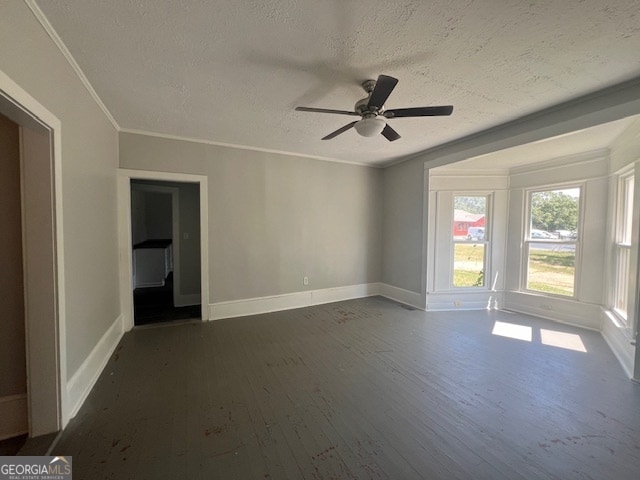 empty room featuring a textured ceiling, ceiling fan, crown molding, and dark hardwood / wood-style floors