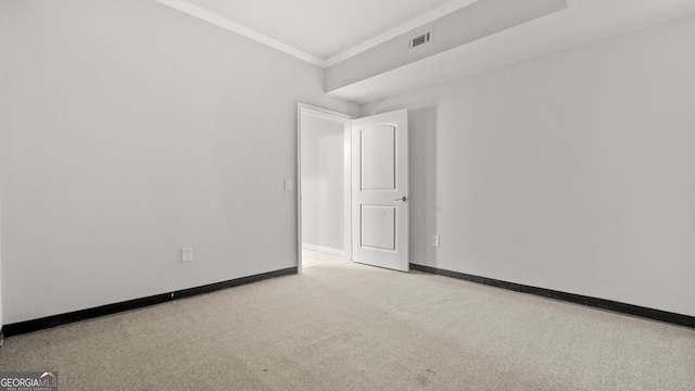 carpeted spare room featuring ornamental molding