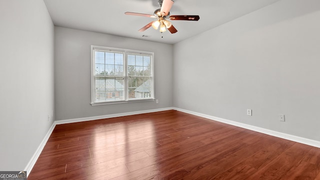 unfurnished room featuring ceiling fan and dark hardwood / wood-style floors