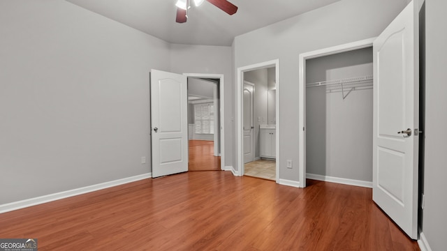 unfurnished bedroom with wood-type flooring, a closet, and ceiling fan