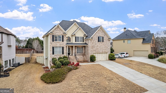 view of front of house featuring central AC and a garage