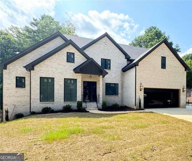 view of front of house with a garage and a front yard