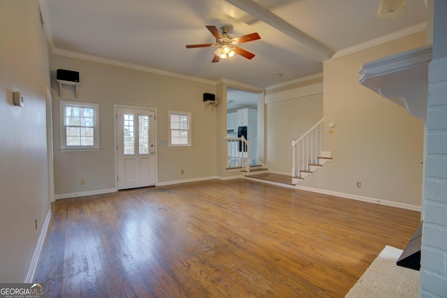 unfurnished living room with wood-type flooring, ornamental molding, and ceiling fan