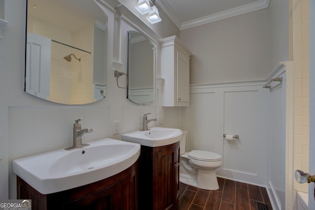 bathroom featuring crown molding, vanity, toilet, and walk in shower