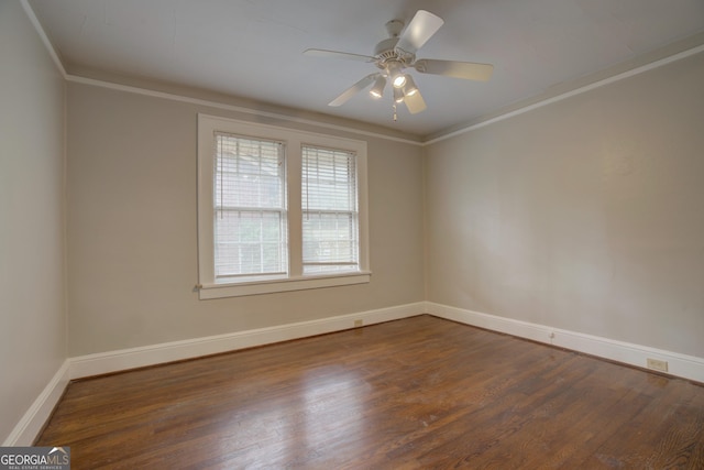 empty room featuring crown molding, dark hardwood / wood-style floors, and ceiling fan