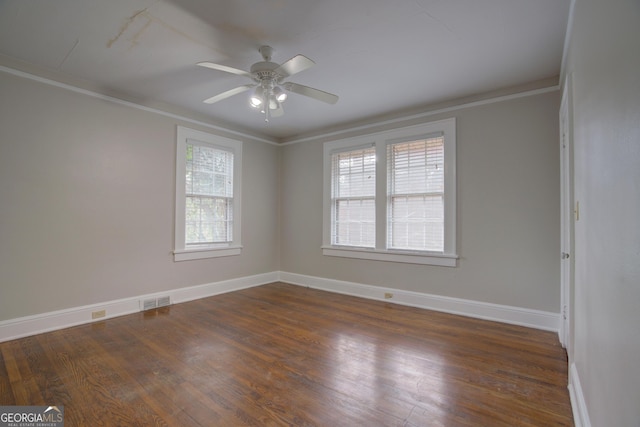 empty room featuring ornamental molding, dark hardwood / wood-style floors, and ceiling fan