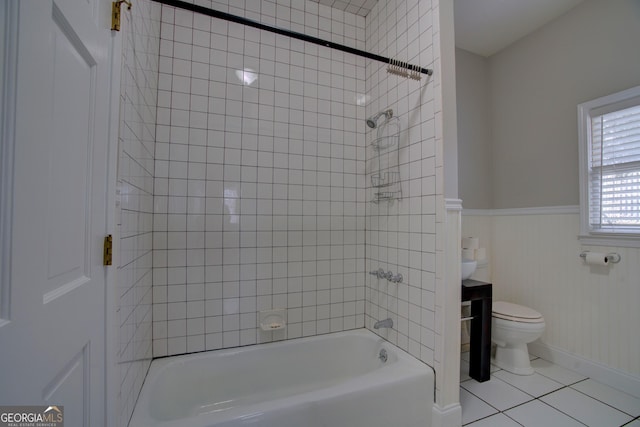 full bathroom featuring tile patterned flooring, vanity, tiled shower / bath combo, and toilet