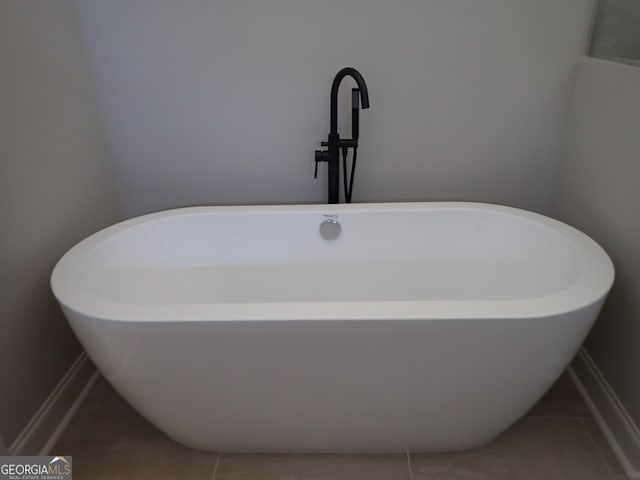 interior details featuring a bath and tile patterned floors