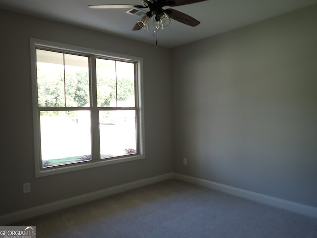 spare room with ceiling fan, carpet flooring, and a healthy amount of sunlight