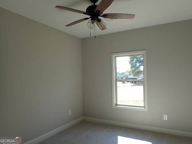 spare room featuring carpet flooring and ceiling fan