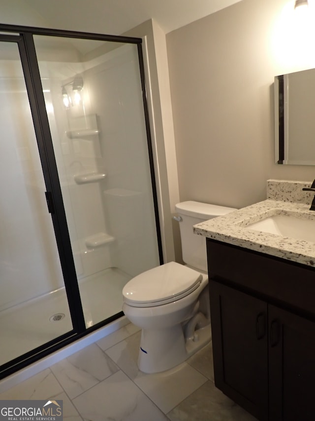 bathroom with tile patterned flooring, toilet, walk in shower, and vanity