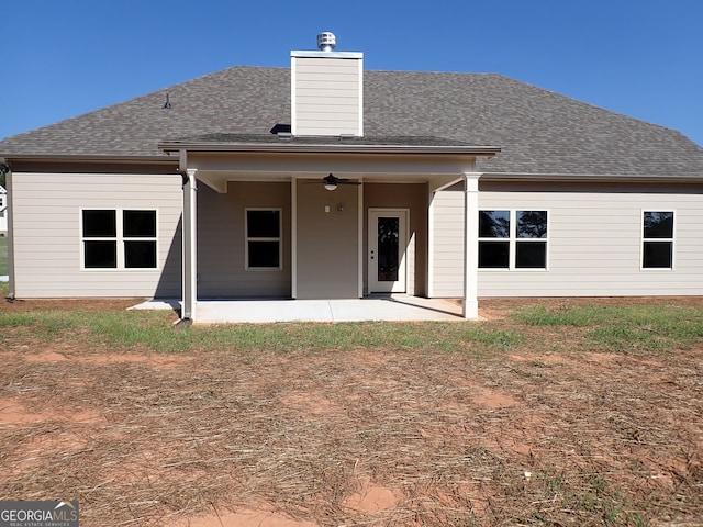 back of property with ceiling fan and a patio area