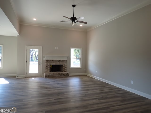 unfurnished living room with hardwood / wood-style flooring, a fireplace, ornamental molding, and ceiling fan