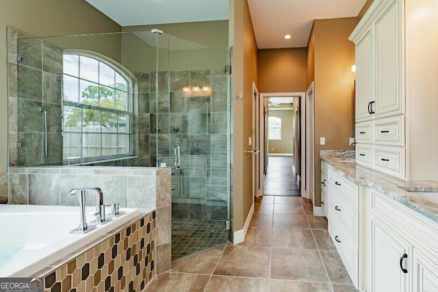 bathroom with vanity, independent shower and bath, and tile patterned flooring