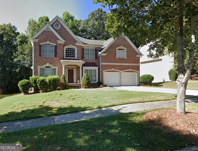 view of front of house with a garage and a front yard