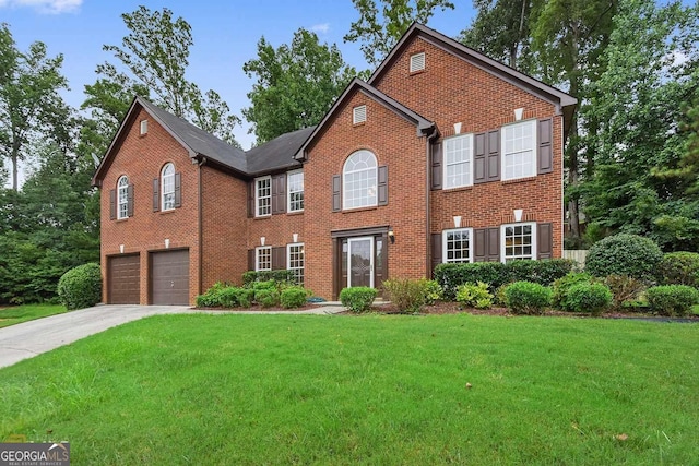 view of front of property featuring a garage and a front lawn