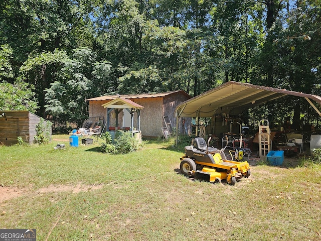 view of yard with a carport and a storage shed