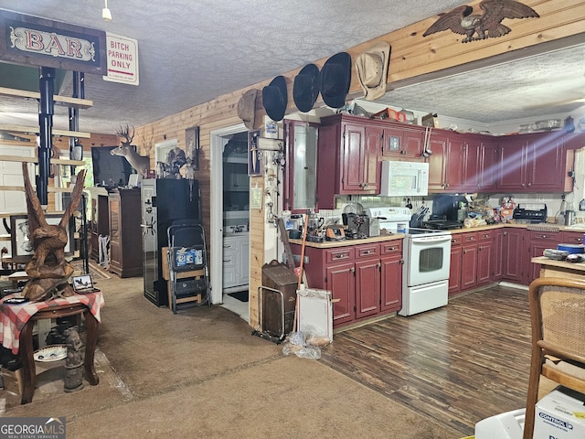 kitchen featuring a textured ceiling, white appliances, and dark hardwood / wood-style flooring