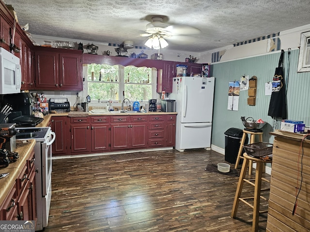 kitchen with a textured ceiling, white appliances, ceiling fan, and dark wood-type flooring