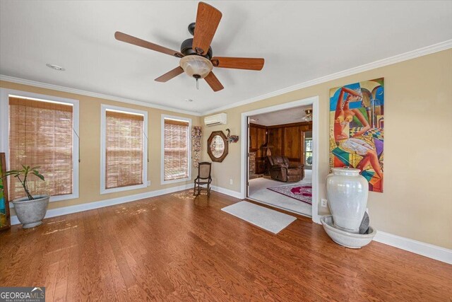 interior space featuring baseboards, wood finished floors, and a ceiling fan