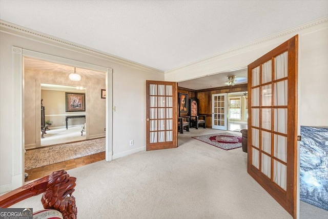 unfurnished room with ornamental molding, carpet flooring, french doors, and baseboards